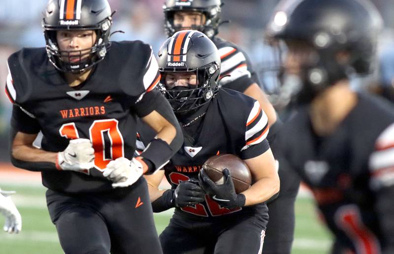 McHenry’s Mick Reidy, center, looks for running room against Crystal Lake South  in varsity boys football at McCracken Field on the campus of McHenry High School in McHenry on Friday, Sept. 5, 2025.