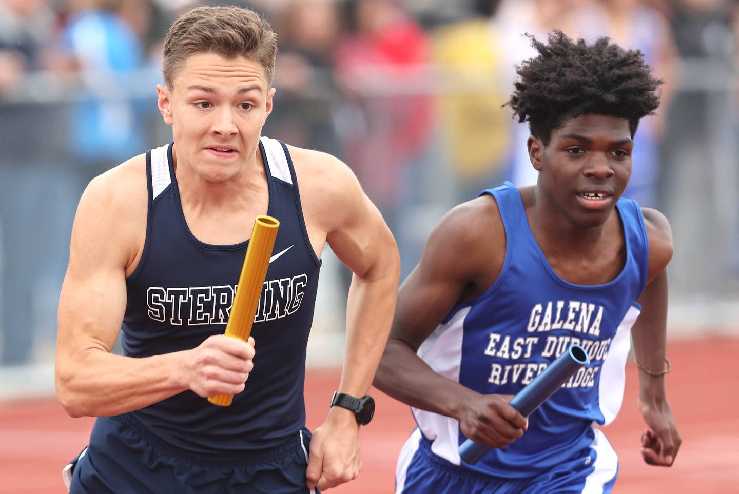 Sterling's Dale Johnson (left) starts the 4x800 meter relay for his team Wednesday, May 18, 2022, at the Class 2A boys track sectional at Rochelle High School.