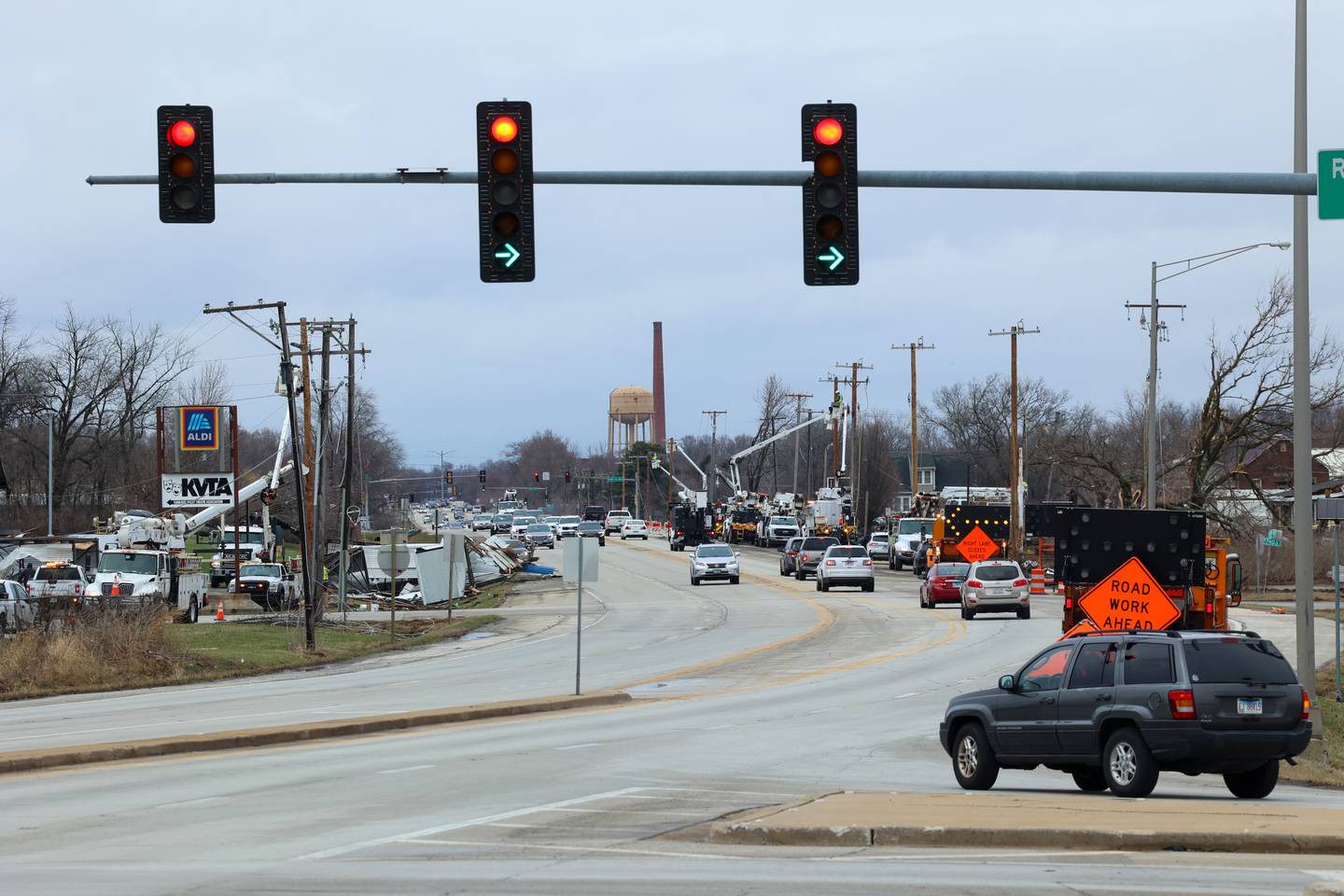 Workers repair downed power lines on Wednesday, March 11, 2026, along South Schuyler Avenue, or U.S. Route 45/52, following damage from a March 10 tornado that passed through Kankakee County.
