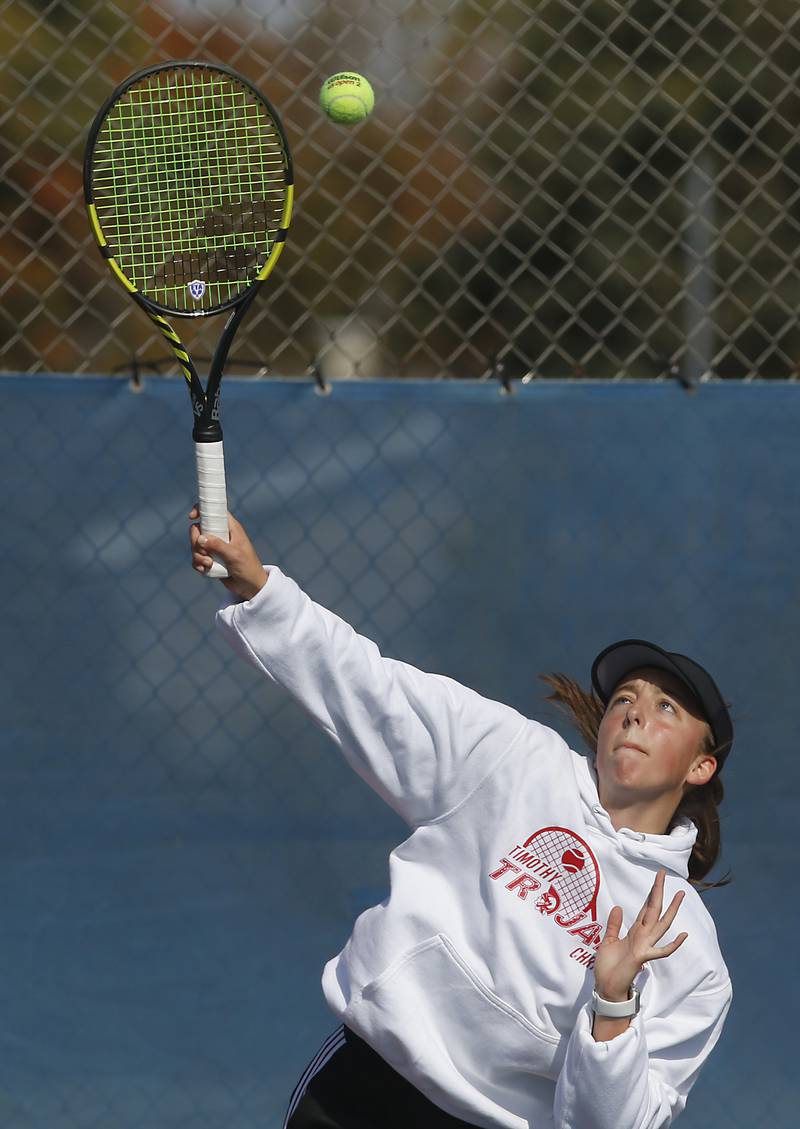 Timothy Christian’s Jane Carter serves the ball Thursday, Oct. 20, 2022, during during the first day of the IHSA State Girls Tennis Tournament at Hoffman Estates High School in Hoffman Estates.