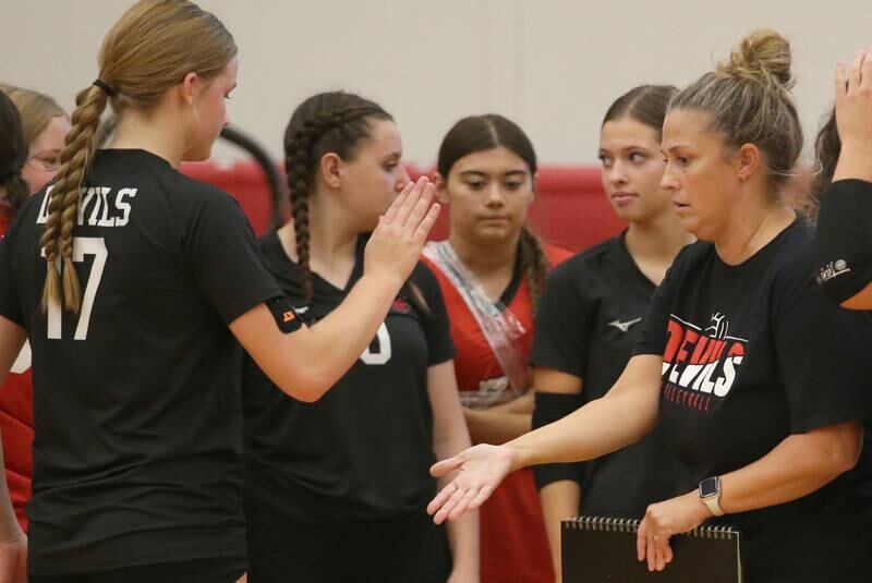 Hall head volleyball coach Carolyn Foster hi-fives player Caroline Morris during a game against Mendota on Tuesday, Sept. 13, 2024 at Hall High School.