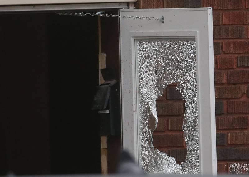 A glass shattered door can be seen around the entrance of a two story apartment building on the corner of Seventh and Charters on Sunday, March 30, 2025 in La Salle. A barricaded armed subject fired shots at officers. Police from across the Illinois Valley assisted in the incident.