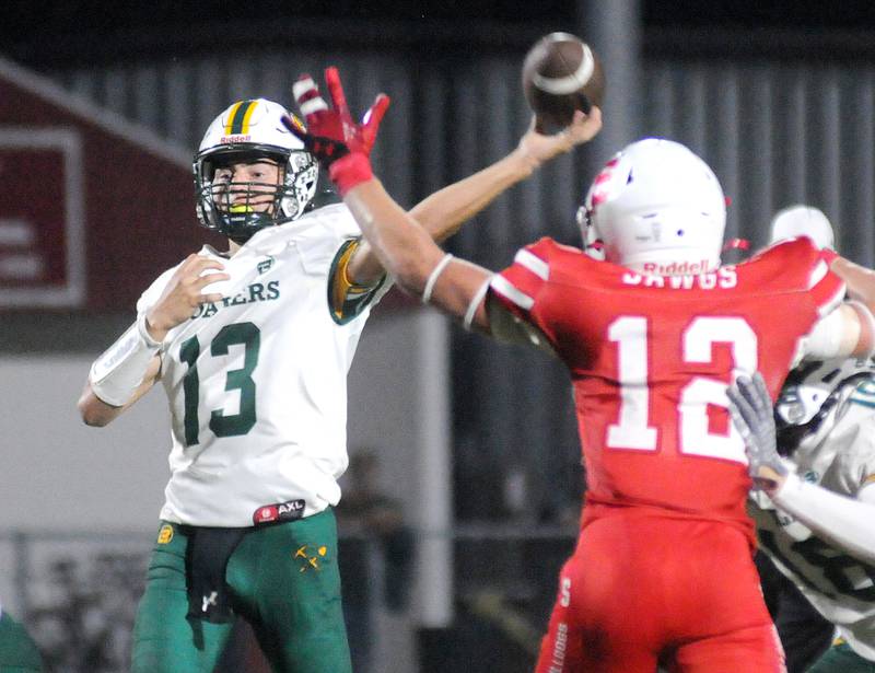 Coal City quarterback Connor Henline (13) passes as Streator defender Riley Stevens tries to block Friday, Sept. 19, 2025 at Doug Dieken Stadium.