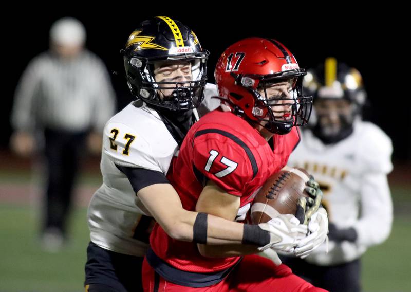 Huntley’s Jacob Zastrow, right, is wrapped up by Andrew’s Jack LoConte in Class 8A  football first-round playoff action at Huntley on Friday.