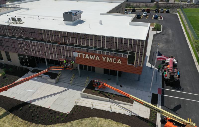 An aerial view of crews installing letters spelling "Ottawa YMCA" on Monday, May 6, 2024 at the new YMCA in Ottawa.