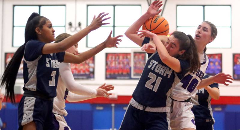 Hampshire’s Sadie Van Horn, back left, and Aubrey Fudala, back right, tussle with South Elgin’s Taleah Banner, front left, and  Molly Stahl, front right, in varsity girls basketball Komaromy Classic tournament  action on Monday, Dec. 29, 2025, at Dundee-Crown High School in Carpentersville.