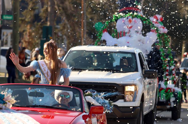Miss Cary-Grove 2024 Kaitlyn Maynor waves from a convertible in a parade as part of Merry Cary events Sunday, Dec. 8, 2024 in Cary.