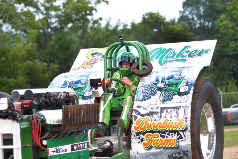 Austin Dornbush of Albany sits in  his 2021 modified tractor "Time Maker" at the  tractor pull at the Ogle County Fair in Oregon on Thursday, July 31, 2025.