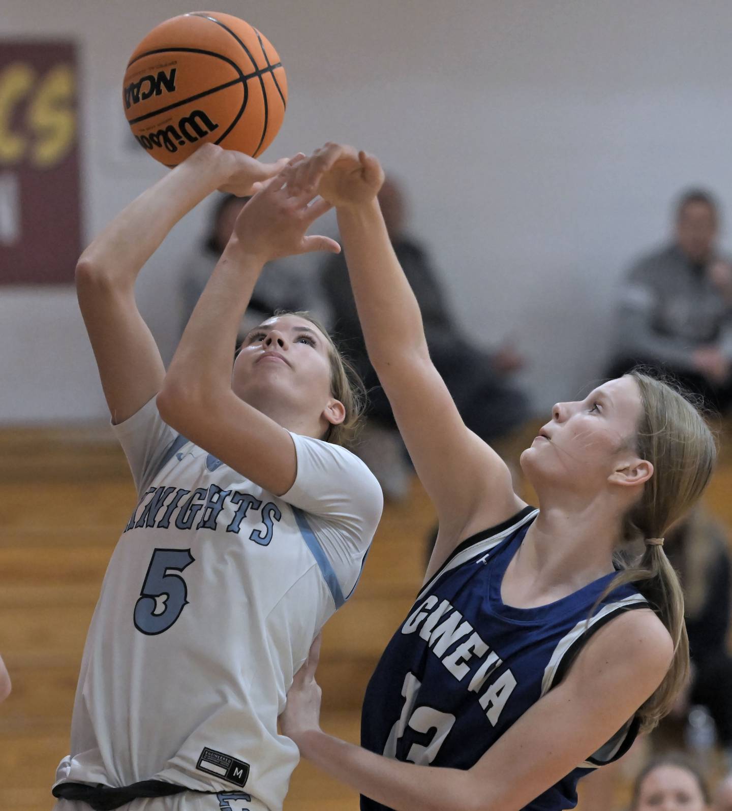Geneva’s Emma Peterson fouls Prospect’s Colleen Shute in a girls basketball game at Montini Catholic High School in Lombard Monday.