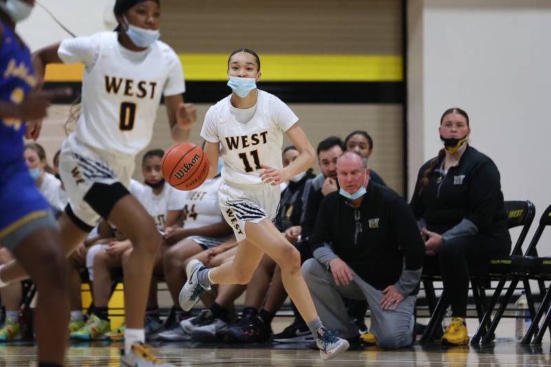 Joliet West’s Caiside Snapp looks for a play up court against Joliet Central in the Class 4A Moline Regional semifinal. Tuesday, Feb. 15, 2022, in Joliet.