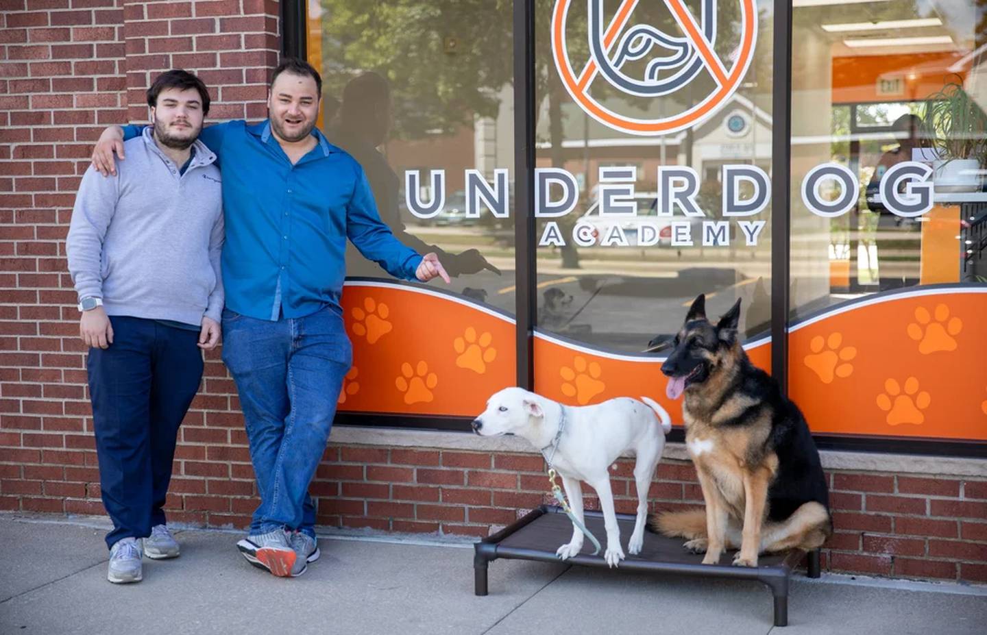 Dog trainer and store manager Henry Schnur and Zachery Holland, dog trainer and owner, of Underdog Academy in Algonquin with Koda and Lola.