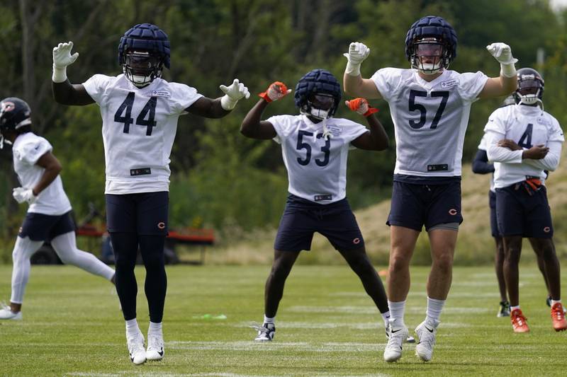 Chicago Bears linebackers Matthew Adams, left, Nicholas Morrow, center, and Jack Sanborn warm up with teammates at the team's training camp, Thursday, July 28, 2022, in Lake Forest.