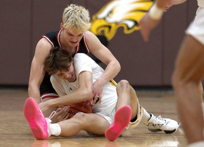 Crystal Lake South’s  Tony Santarelli, bottom, tussles with Barrington’s Nick Peipert in Hinkle Holiday Classic boys basketball tournament game action at Jacobs High School Tuesday.