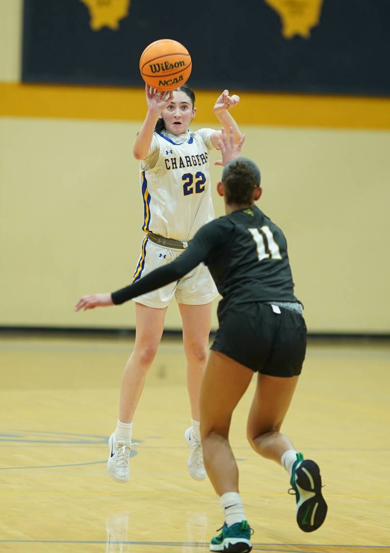 Aurora Central Catholic's Brooklyn Murphy (22) shoots a three pointer against Waubonsie Valley's Nicole Douglas (11) during a basketball game at Aurora Central Catholic High School on Thursday, January 30, 2025.