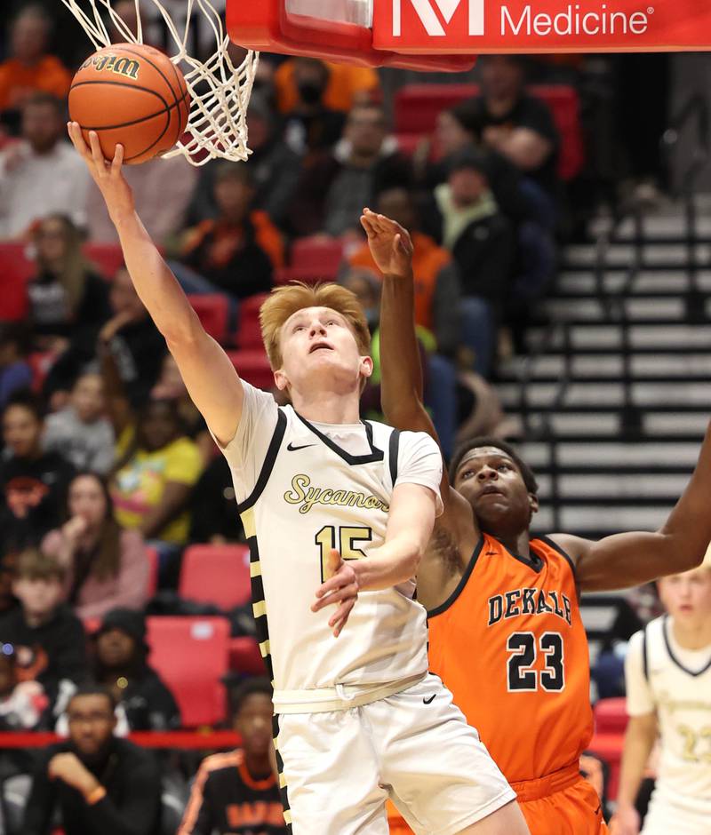 Sycamore's Teague Hallahan scores in front of DeKalb's Davon Grant during the First National Challenge Friday, Jan. 27, 2023, at The Convocation Center on the campus of Northern Illinois University in DeKalb.