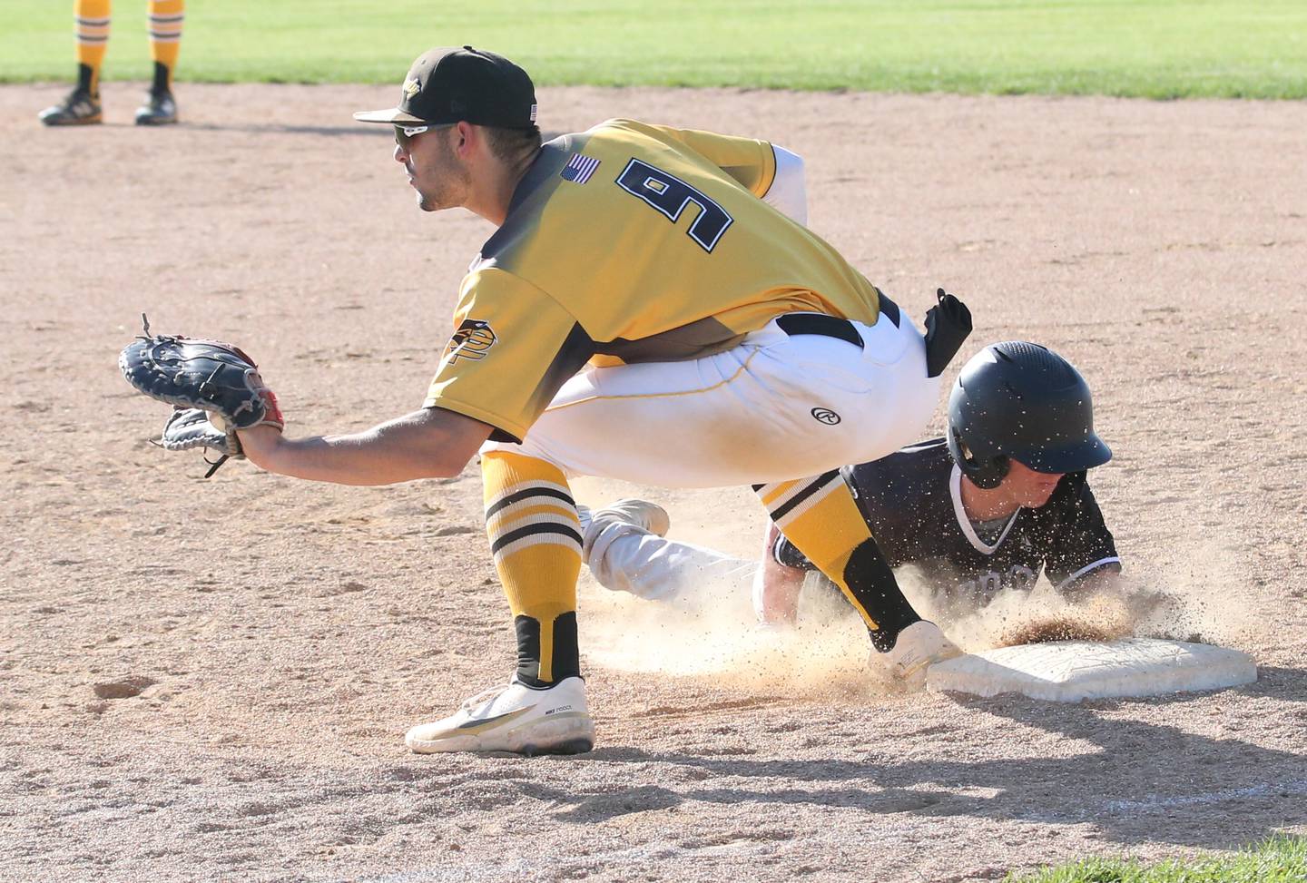 Woodland/Flanagan-Cornell's Connor Dodge dives safely back to the first-base bag as Putnam County first baseman Jackson McDonald receives a throw Thursday, May 4, 2023, at Putnam County High School.
