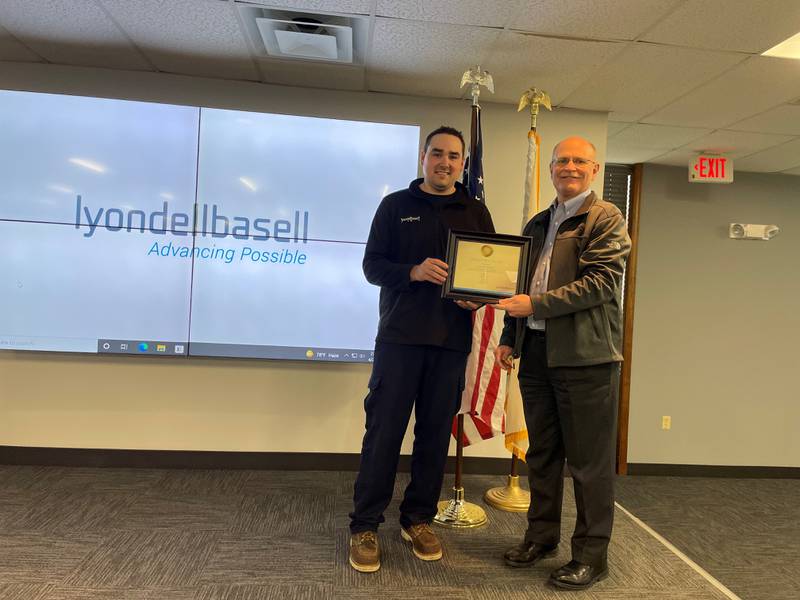 Luke Halterman (left) is presented with receiving  CEO Lifesaver Award from LyondellBasell site manager Randy Tatum