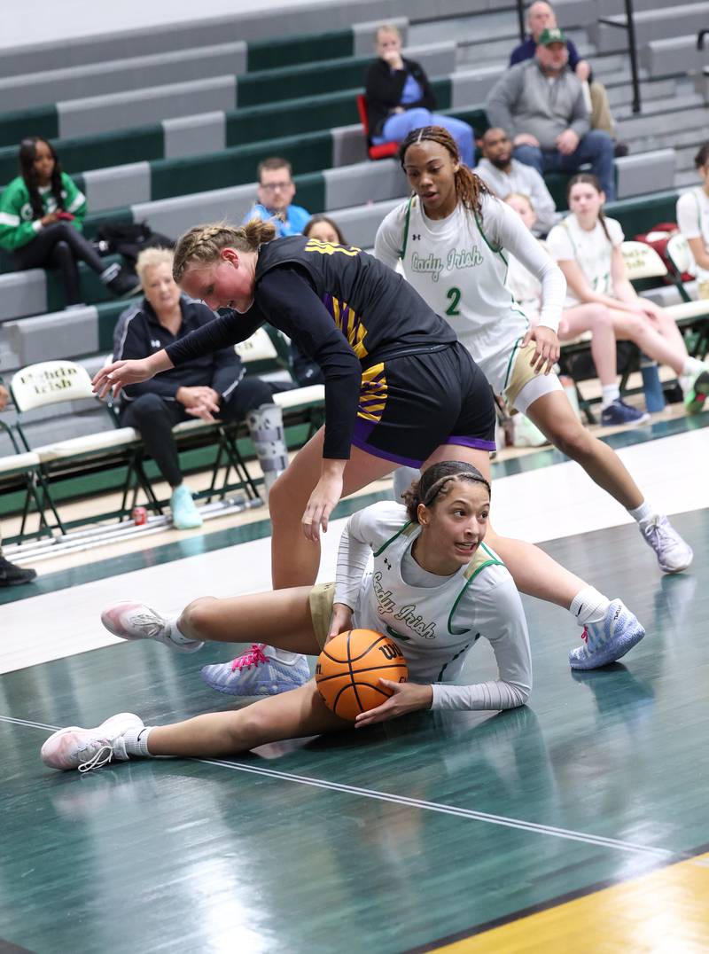 Bishop McNamara's Trinitee Thompson looks to pass after securing a loose ball during the Fightin' Irish's 67-27 victory over Chicago Christian on Monday, Jan. 26, 2026.