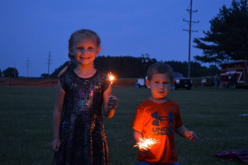Siblings Allie Sasscer, 5, and Jack Sasscer, 2, both of Forreston, play with sparklers on June 2, 2023, during Leaf River Summer Daze, shortly before the fireworks show.