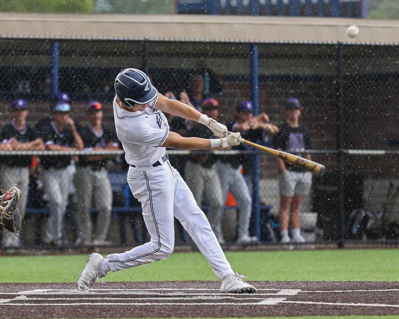 Oswego East's Mike Polubinski (1) connects on a pitch during Class 4A Romeoville Sectional semifinal between Oswego East at Downers Grove North.  May 31, 2023.