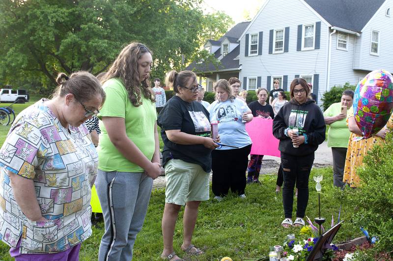 About 30 people attended a vigil in memory of the victims of arson in June of 200.