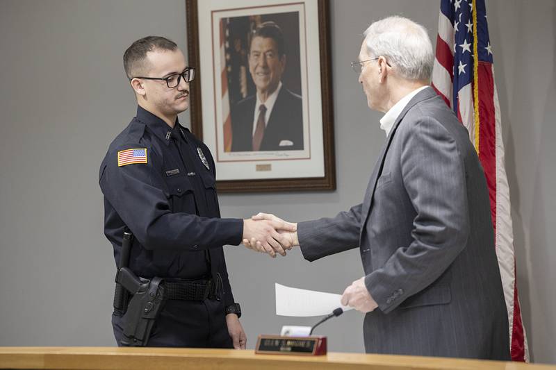 Newly sworn in Dixon Police Officer Griffey Rodriguez shakes hands with Mayor Glen Hughes Monday, Feb. 2, 2026.