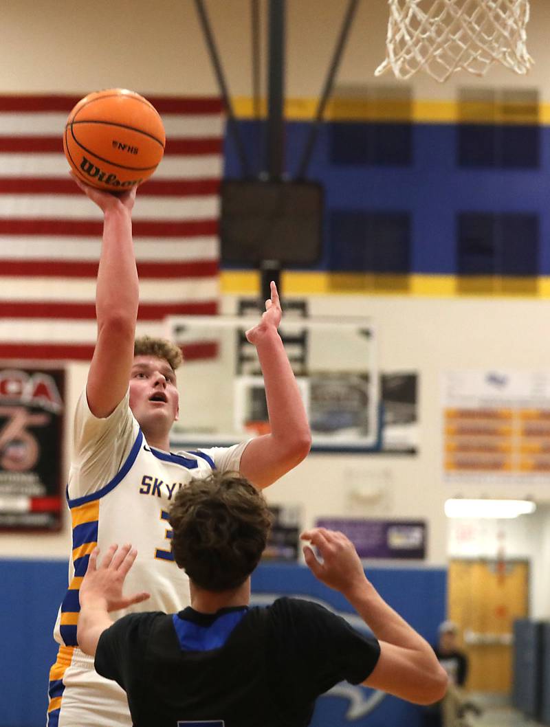 Johnsburg's Jayce Schmitt shoots the ball over Woodstock's Max Beard during a Kishwaukee River Conference boys basketball game on Friday, February. 13, 2026, at Johnsburg High School.