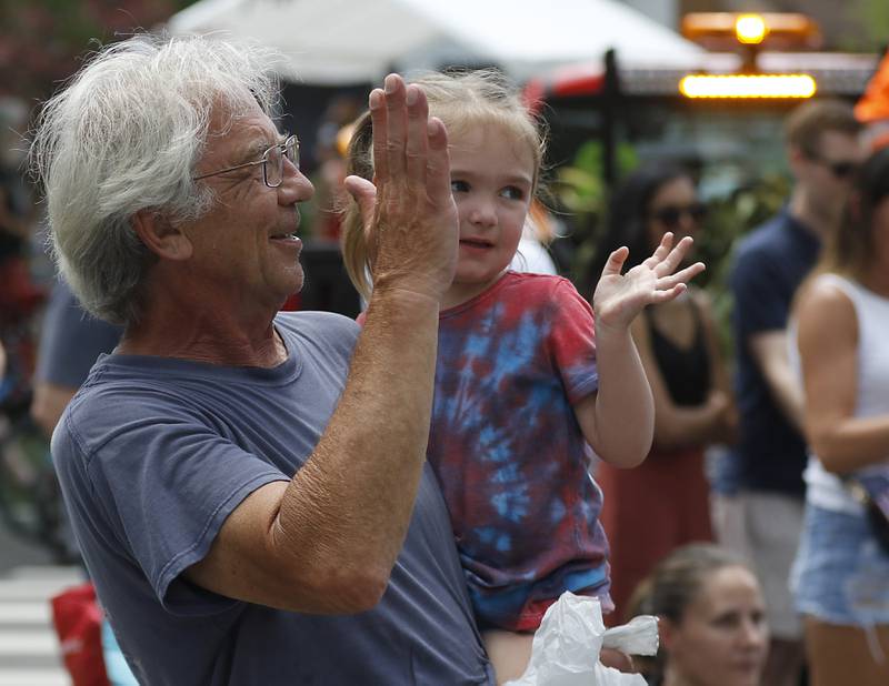 Joel Jerabek and his granddaughter Rose Jerabek, 3, wave to a float on Sunday, July 6, 2024, during Crystal Lake’s annual Independence Day Parade on Dole Avenue in Crystal Lake.