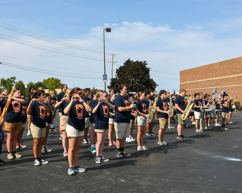 Oswego High School band warms up and plays Amazing Grace before the start of the homecoming parade on Sunday Sept. 15, 2024, that started and ended at Oswego High School.