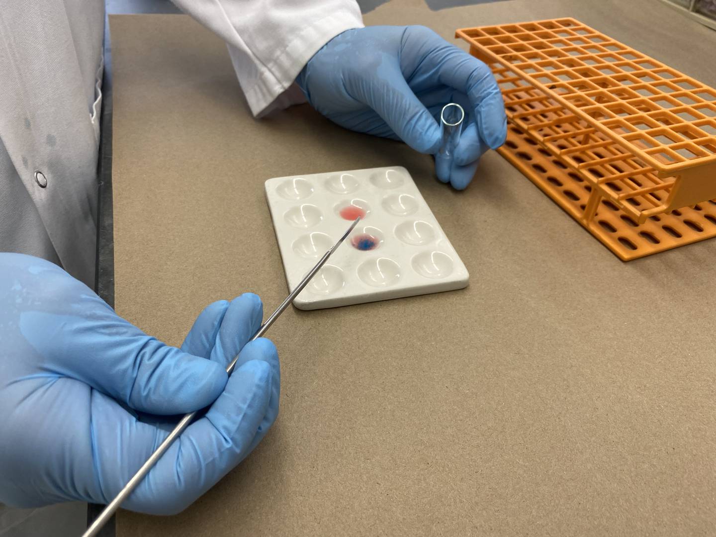 A forensic chemist with the Drug Enforcement Administration North Central Forensic Laboratory in Chicago tests seized counterfeit pills for presence of fentanyl.