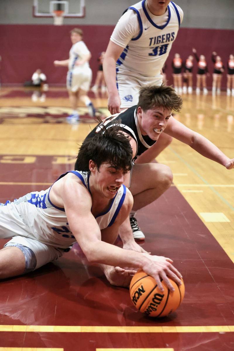 Princeton's Noah LaPorte and Byron's Caden Considine scramble for a loose. balli n Wednesday's sectional semifinals at Marengo. Princeton won 46-42 to advance to Friday's championship against Rock Falls.