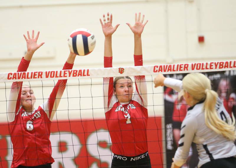 L-P's Maggie Boudreau with the help of teammate Aubrey Duttlinger blocks a spike from Kaneland's Mylee Crosby on Tuesday, Oct. 7, 2025 in Sellett Gymnasium at L-P High School.