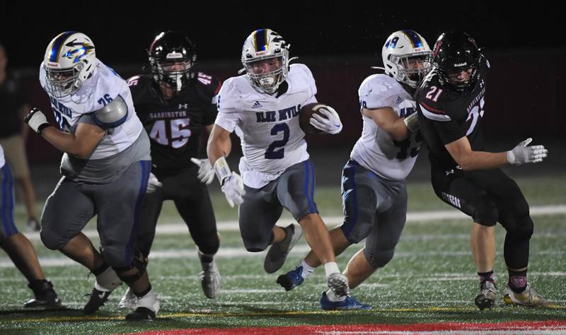 Warren’s Donovan McNeal runs against Barrington at Barrington High School Friday, August 25, 2023.