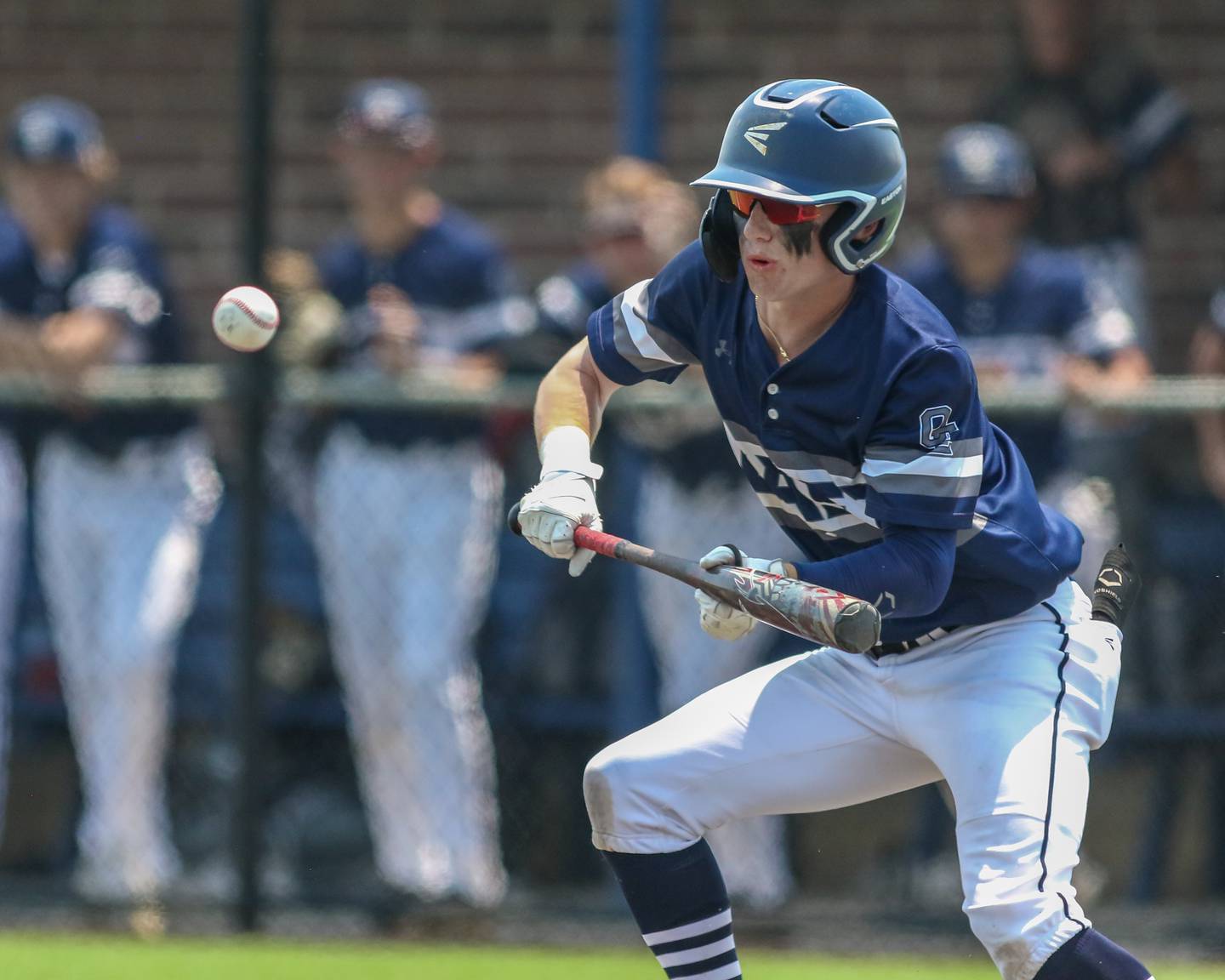 Oswego East's Cody Haynes (13) offers a bunt during Class 4A Romeoville Sectional final game between Oswego East at Oswego.  June 3, 2023.