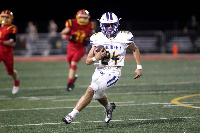 Wheaton North’s Jake Williams carries the ball during a game at Batavia on Friday, Sept. 22, 2023.