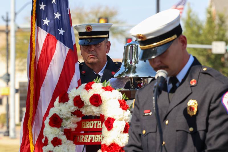 Bourbonnais Fire Protection District Battalion Chief Ken Gebhardt, left, rings the bell in honor of the fallen as Lt. Wyatt Gustafson gives the "Bell Speech" during the 44th Kankakee County Fallen Firefighter Memorial Service on Friday, Oct. 3, 2025.