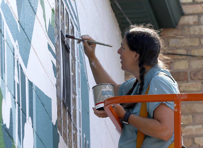 Jenny Mathews paints mural on Thursday, June 19, 2025, on the side of the McHenry Brewing Co., in McHenry. This is one of two new McHenry murals in McHenry.