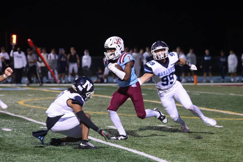 Kankakee's Ezekiel Sherrod evades two Nazareth defenders on a punt return during Kankakee's 33-12 loss to Nazareth on Friday, Aug. 29, 2025.