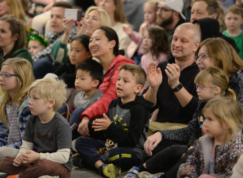 Craig Shaffer of Downers Grove and his son Bennett enjoy watching the Trinity Irish Dancers at the Downers Grove Library Saturday, March 16, 2024.