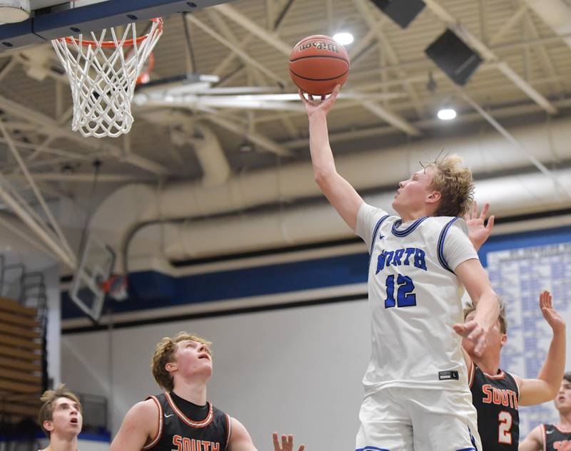 St. Charles North's Parker Reinke (12) takes a shot against during a game on Friday, December 2, 2022.