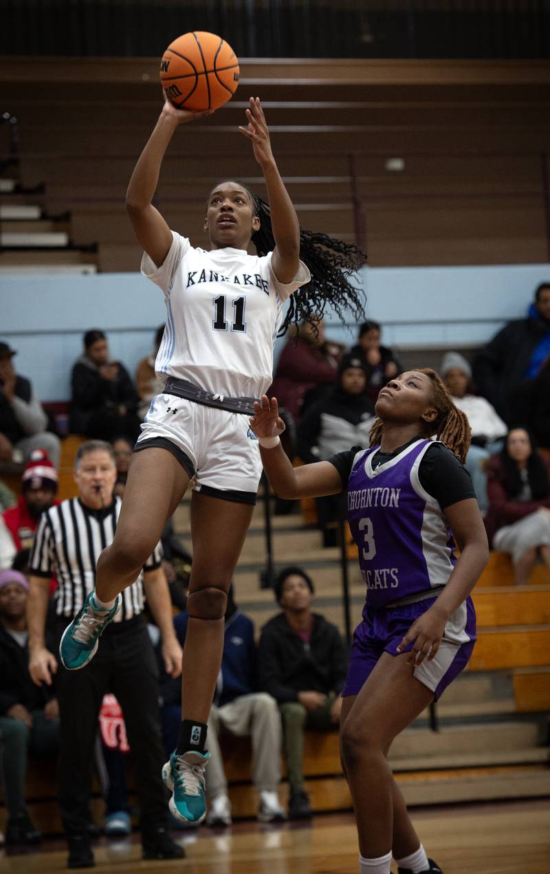 Kankakee's Shania Johnson, left, elevates for a shot over Thornton's Destinee Majors, right, in a game on Thursday, December 4, 2025.