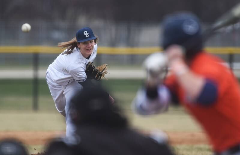 Oswego East pitcher Griffin Sleyko throws to Naperville Central's Cole Clemens during Wednesday's baseball game in Naperville.