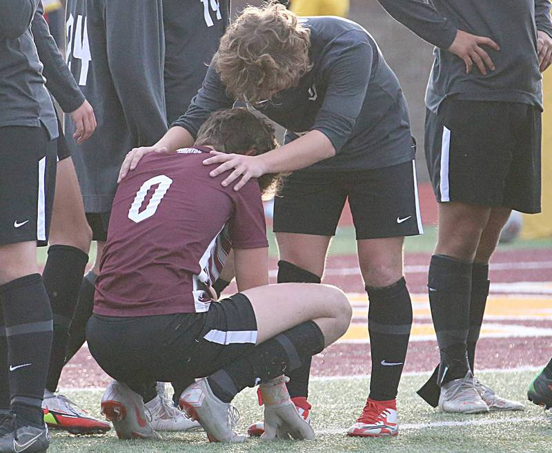 Wheaton Acadey's Scotty Murray consoles keeper Declan Finnegan (0) after failing to stop the last penalty kick from Timothy Christian during the Class 1A State soccer third place game on Saturday, Oct. 29, 2022 at EastSide Centre in Peoria.