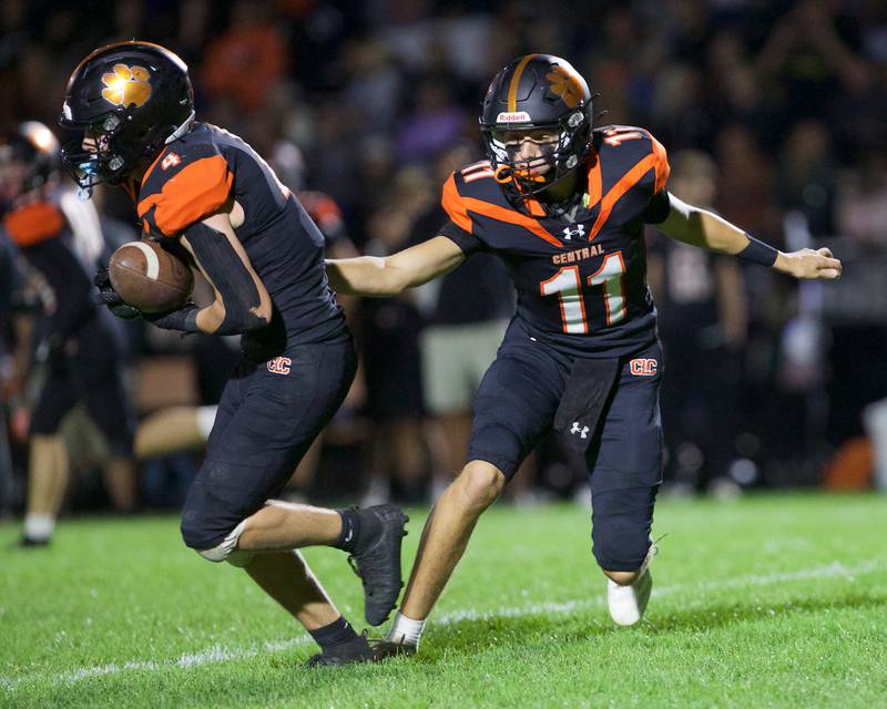 Crystal Lake Central's Brett Kramer hands the ball off to Carter Kelley against Crystal Lake South on Friday, Sept. 27,2024 in Crystal Lake.