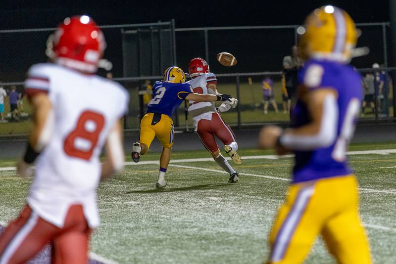 Hall's Brody Bosi attempts to reel in a pass while being chased down by Mendota's Keegan Beetz during the game at The Jeff Prusator Athletic Complex on September 12, 2025 at Mendota High School.