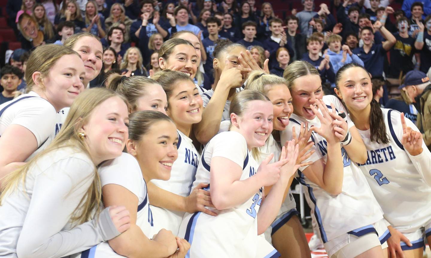 Members of the Nazareth girls basketball team pose for a photo after winning the Class 4A State girls basketball championship game on Saturday, March 7, 2026 at CEFCU Arena in Normal.