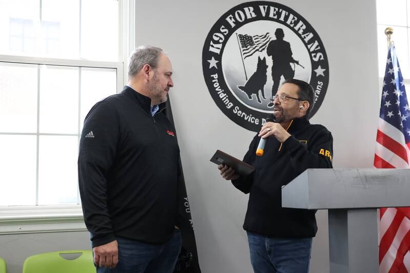 K9s for Veterans CEO and founder Michael Tellerino presents a plaque to Joliet Electric Motors CEO Tim Tibbon. K9s for Veterans hosted a ribbon-cutting ceremony for the opening of its Joliet training campus on Wednesday, Feb. 15, 2023, in Joliet.