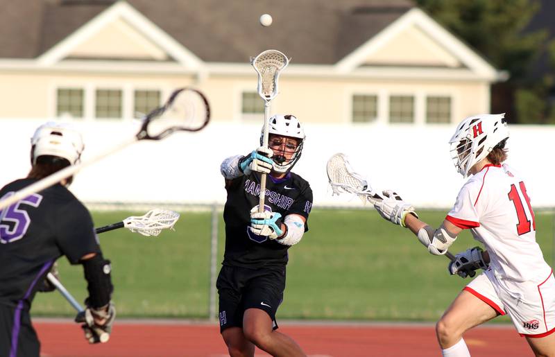 Hampshire’s Chase Lorbiecki passes the ball in varsity lacrosse at Huntley Thursday night.