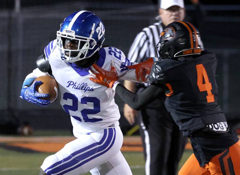 Phillips' Wellington Hall tries to break free from DeKalb's Kirk Johnson Friday, Sept. 5, 2025, during their game at DeKalb High School.