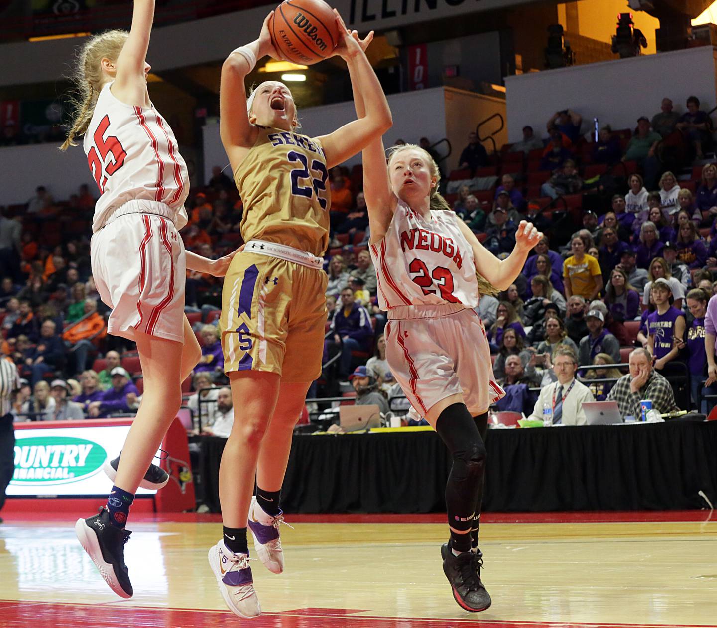 Serena's Katie Baker (22) pulls up in the lane to shoot over Neoga's Sydney Richards (25) and Gracie Eaton (23) during the Class 1A third-place game on Thursday, March 3, 2022, at Redbird Arena in Normal.